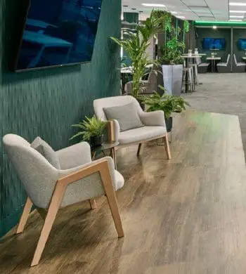 chairs in a room with a tv on the wall