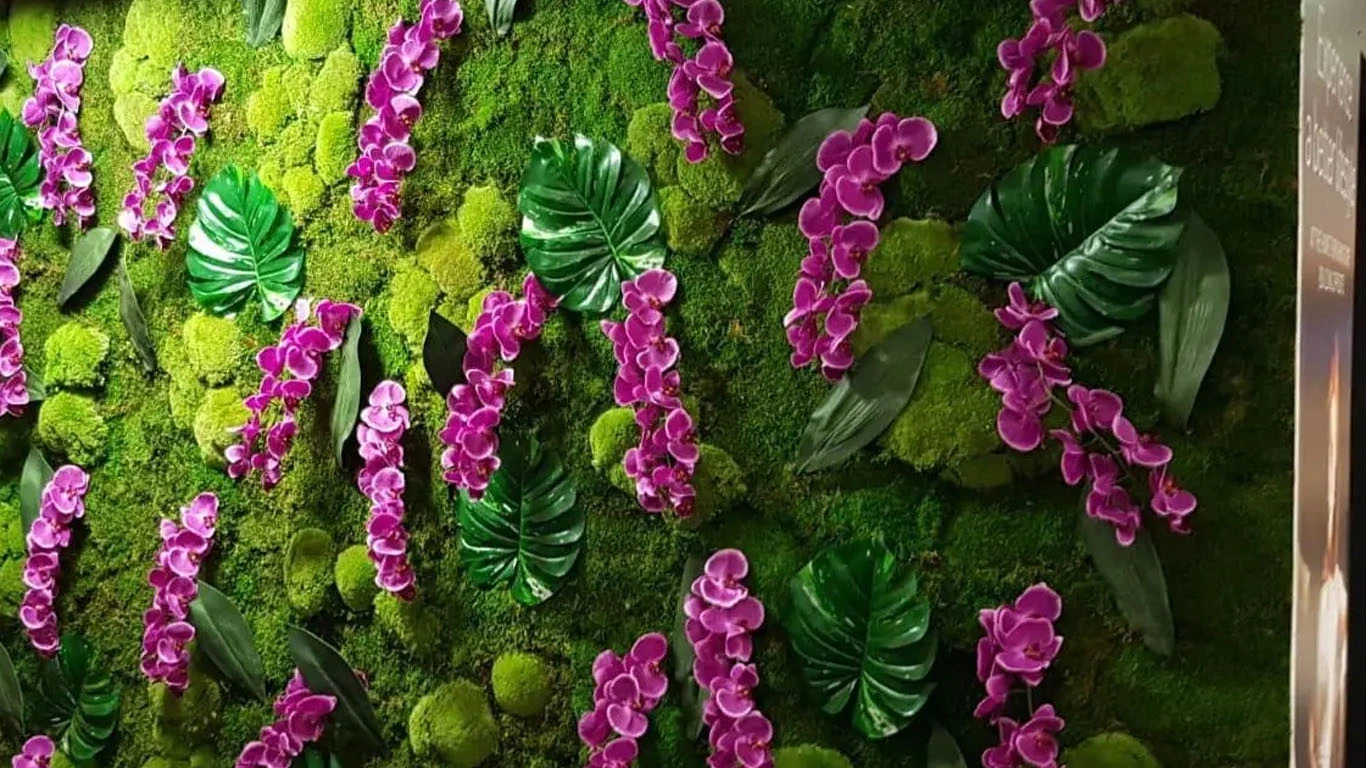 Moss wall with purple flowers provided for Housing Manchester offices.